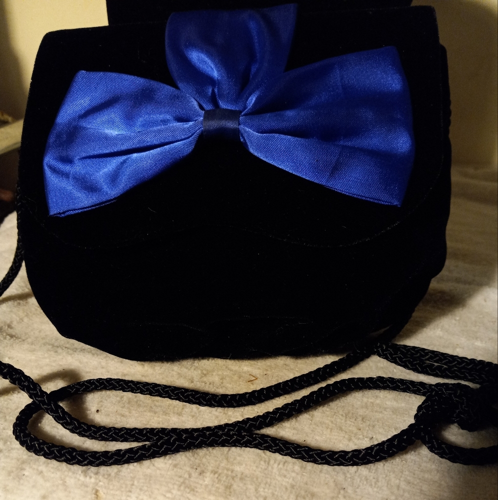 Used,not new,never used,slightly damaged  repaired black velvet bagwith blue bow